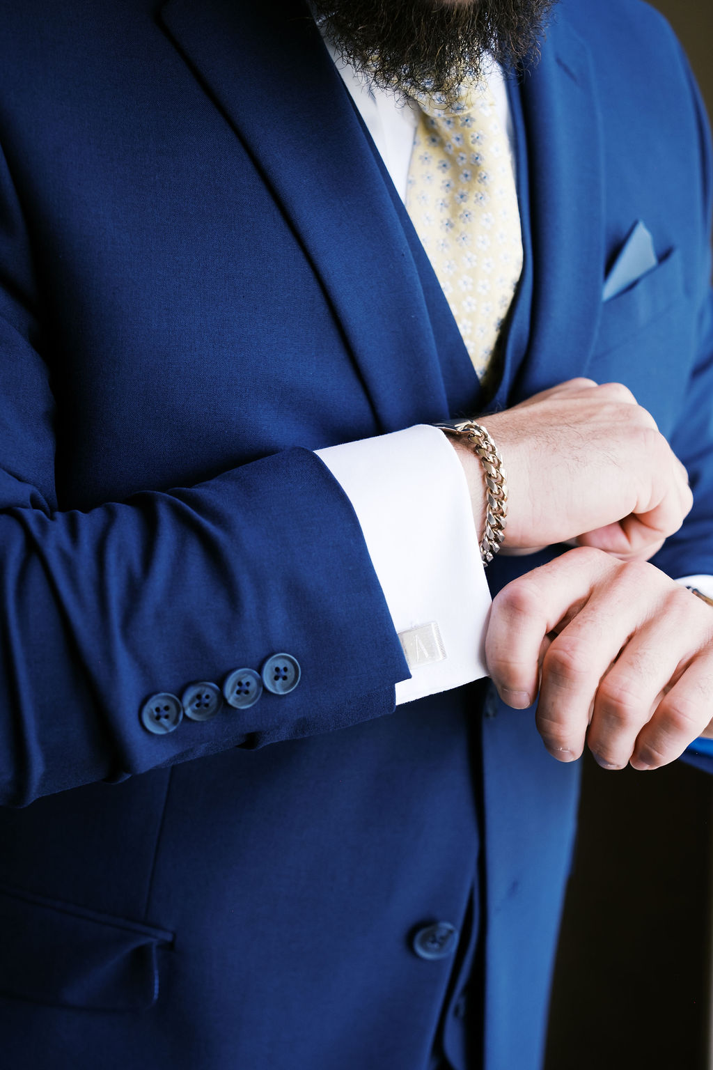 close up of groom's cufflinks and bracelet