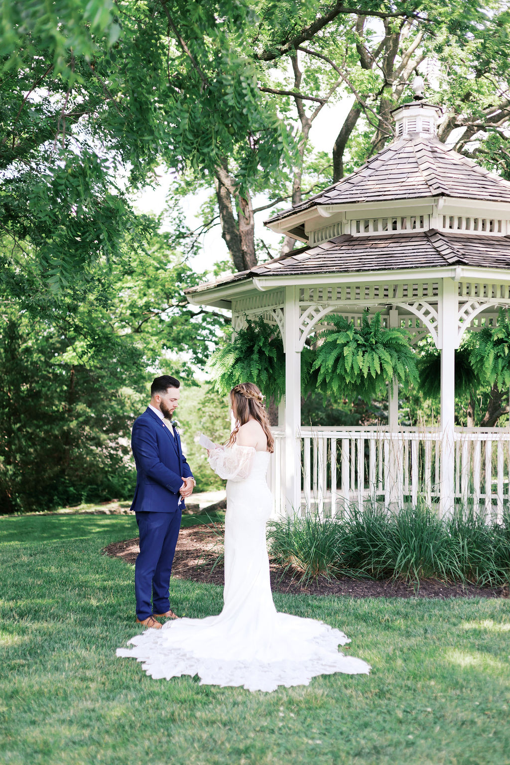 bride reading vows to groom in front of the gazebo at hawthorne house