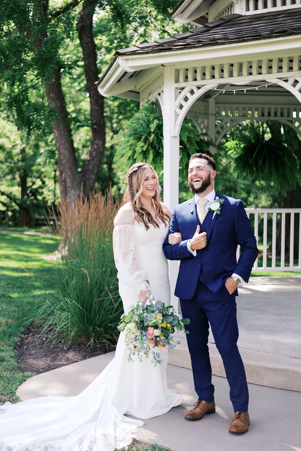bride and groom laughing in front of the gazebo at hawthorne house