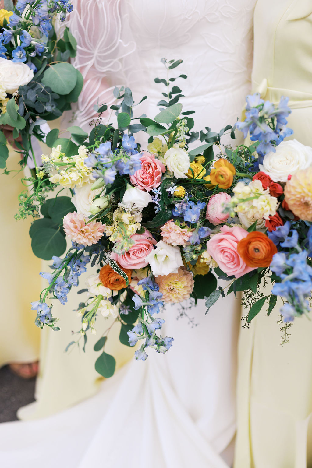 colorful bridal bouquet surrounded by bridesmaids in yellow dresses