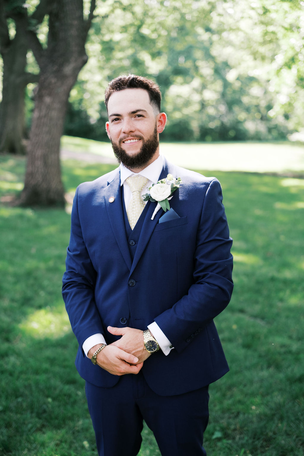 portrait of groom in blue suit smiling