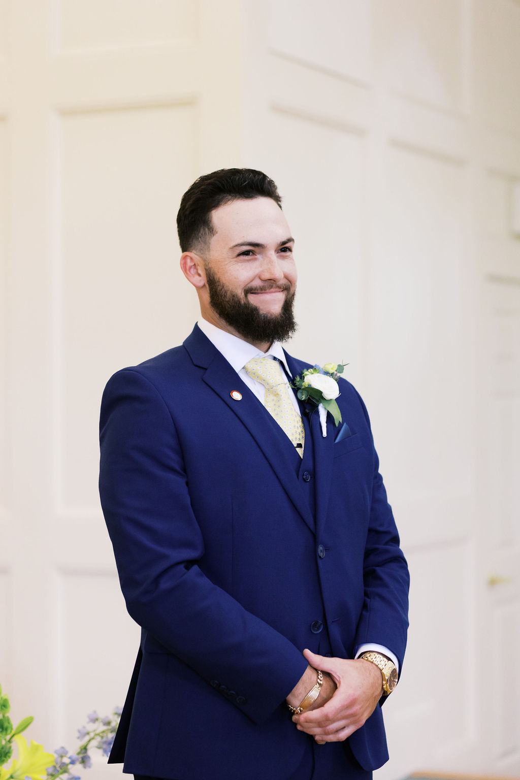 groom waiting at the altar for bride and smiling
