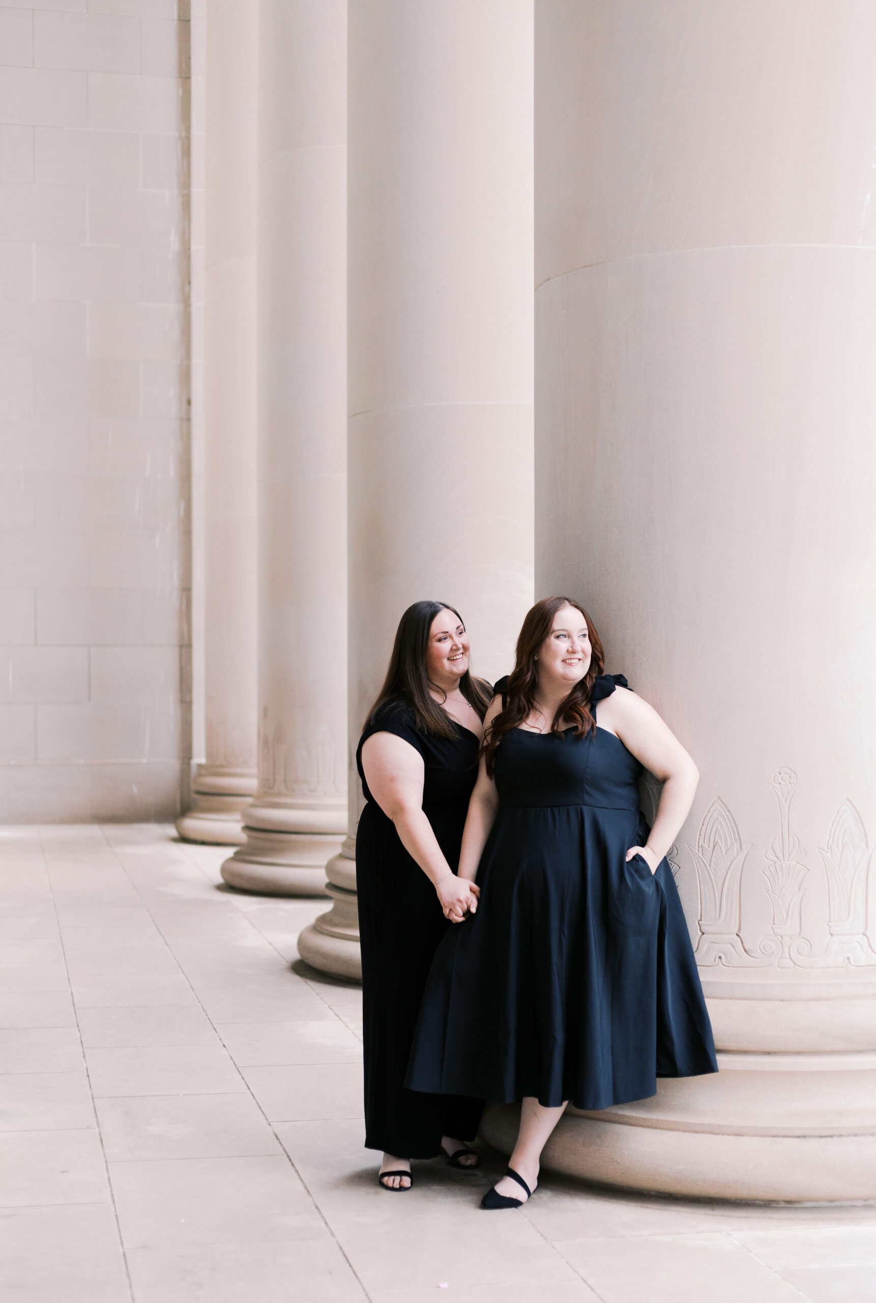 a nelson atkins museum of arts engagement session featuring two brides in black dresses