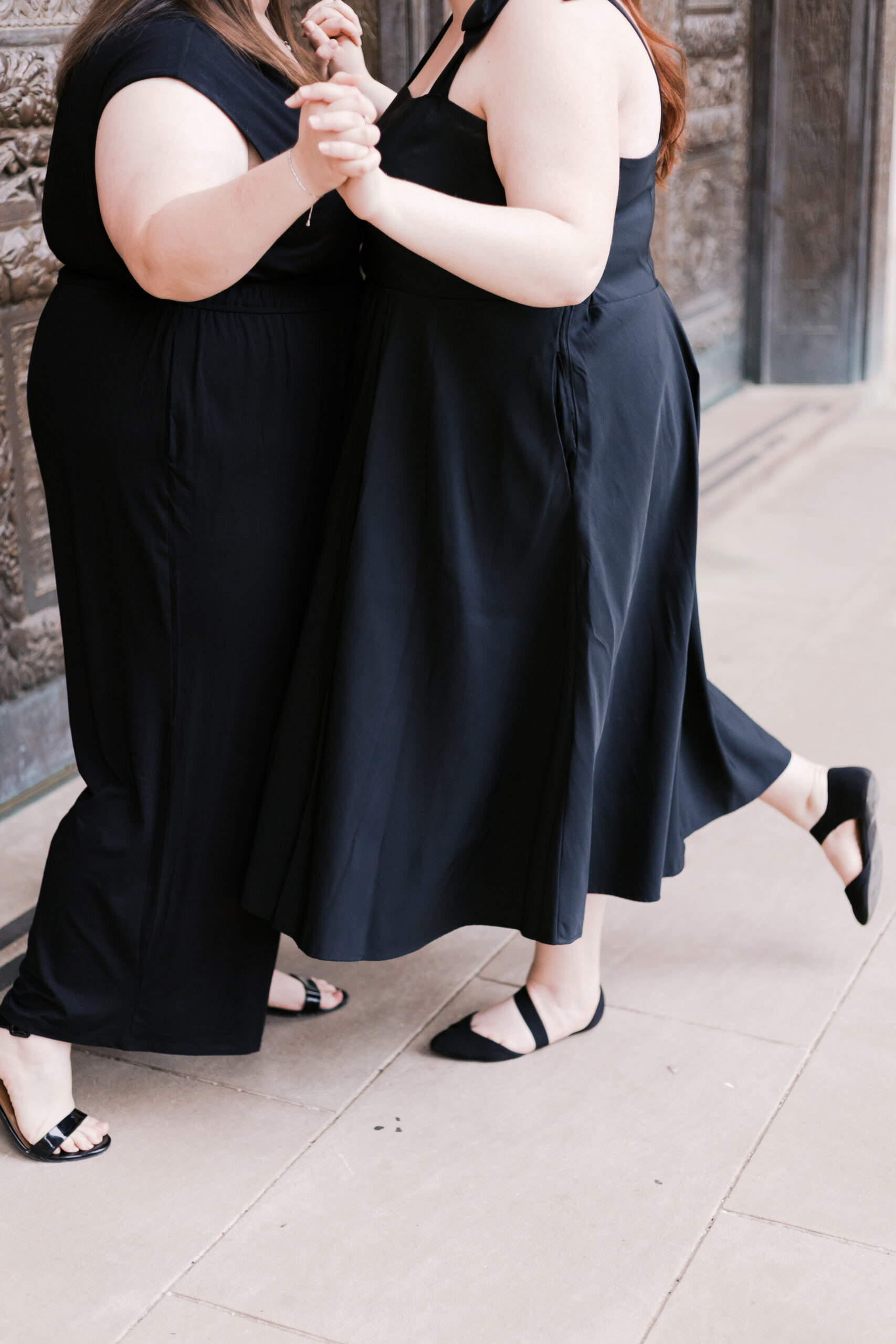 a nelson atkins museum of arts engagement session featuring two brides in black dresses