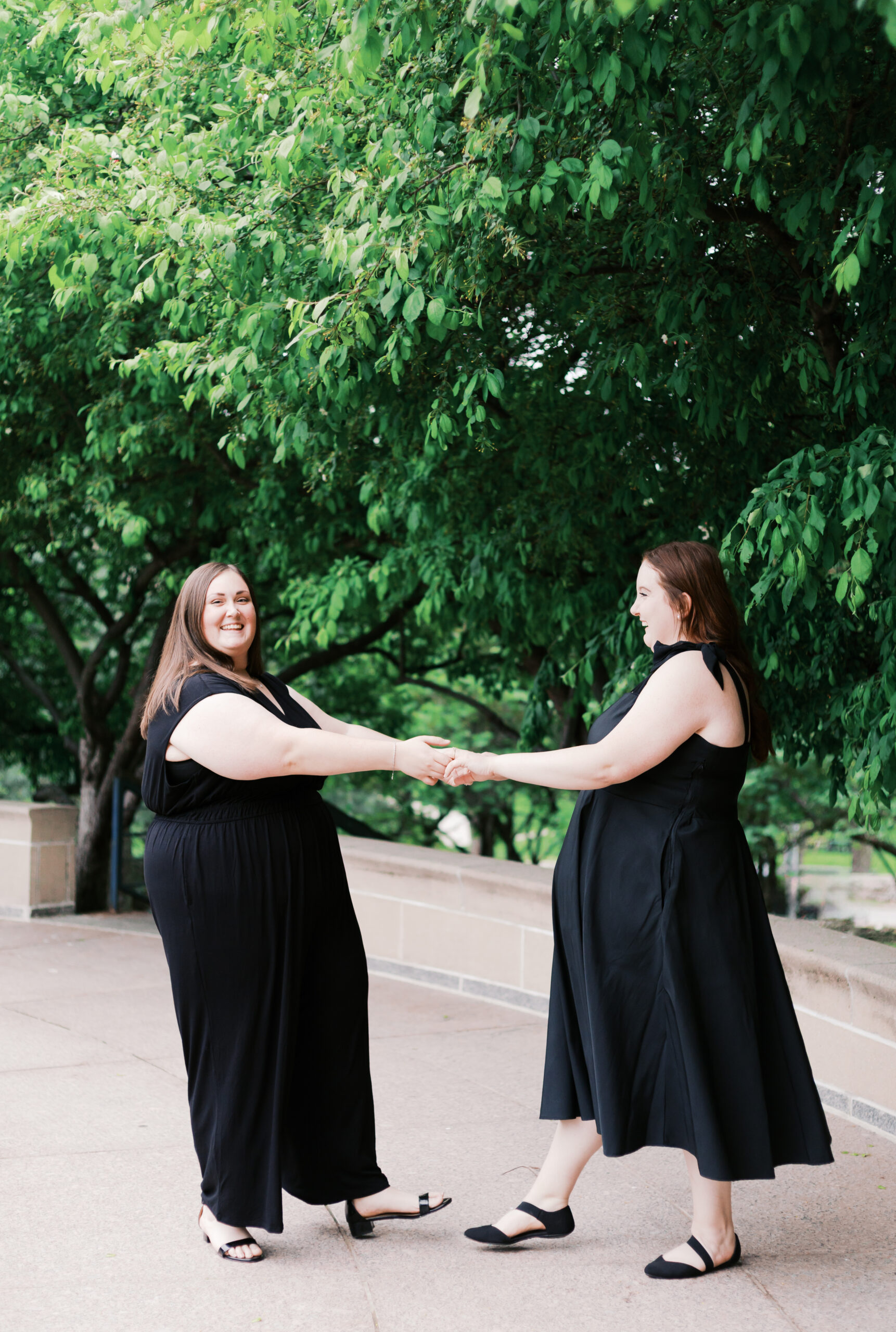 a nelson atkins museum of arts engagement session featuring two brides in black dresses