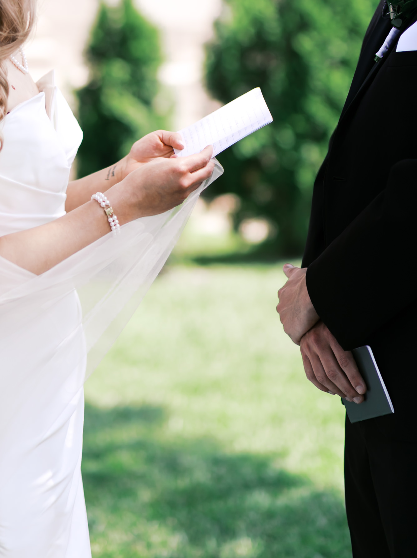 Close up of a bride and groom holding vow books
