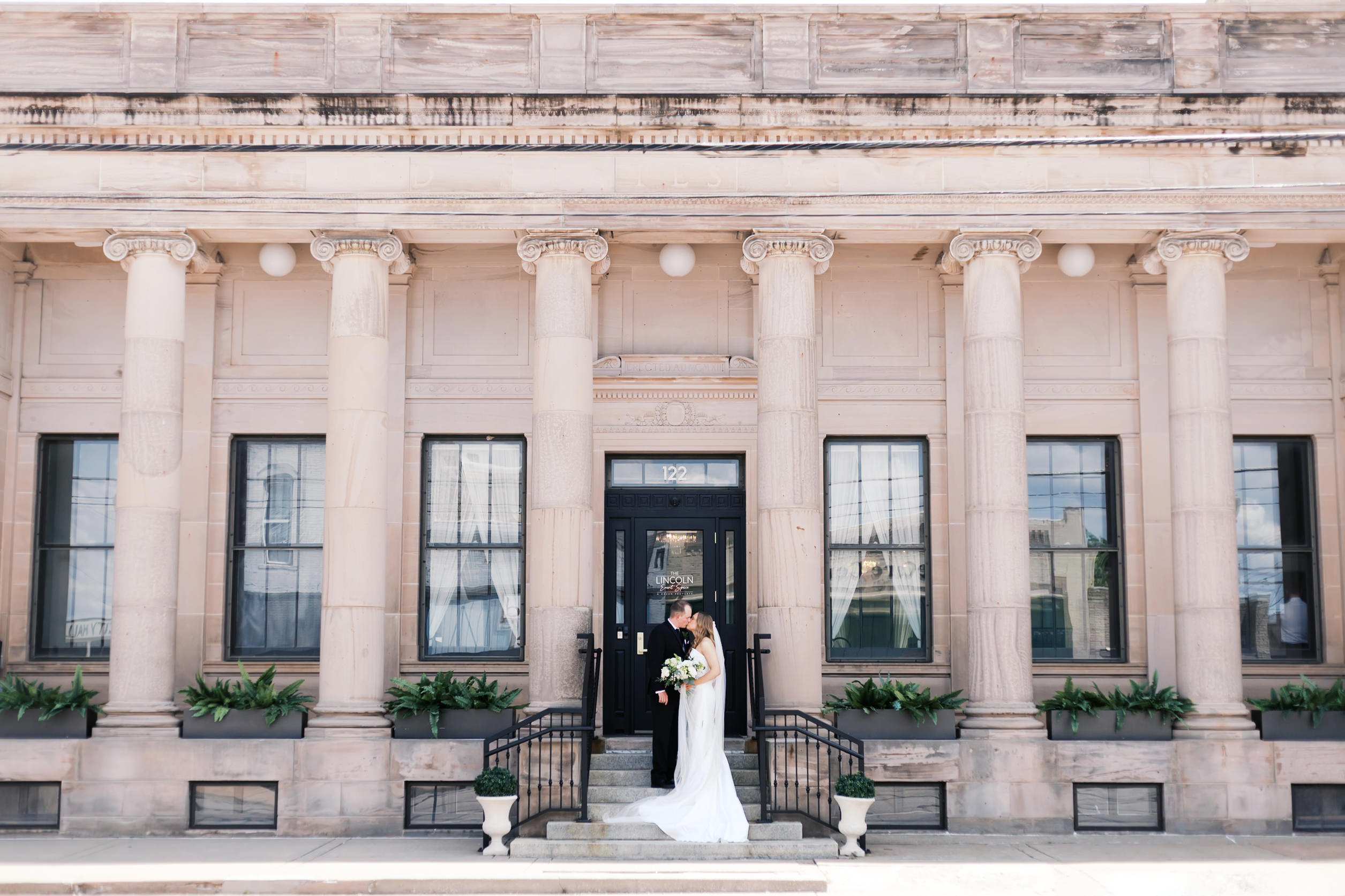 Bride and Groom kissing portrait outside Lincoln Event Space