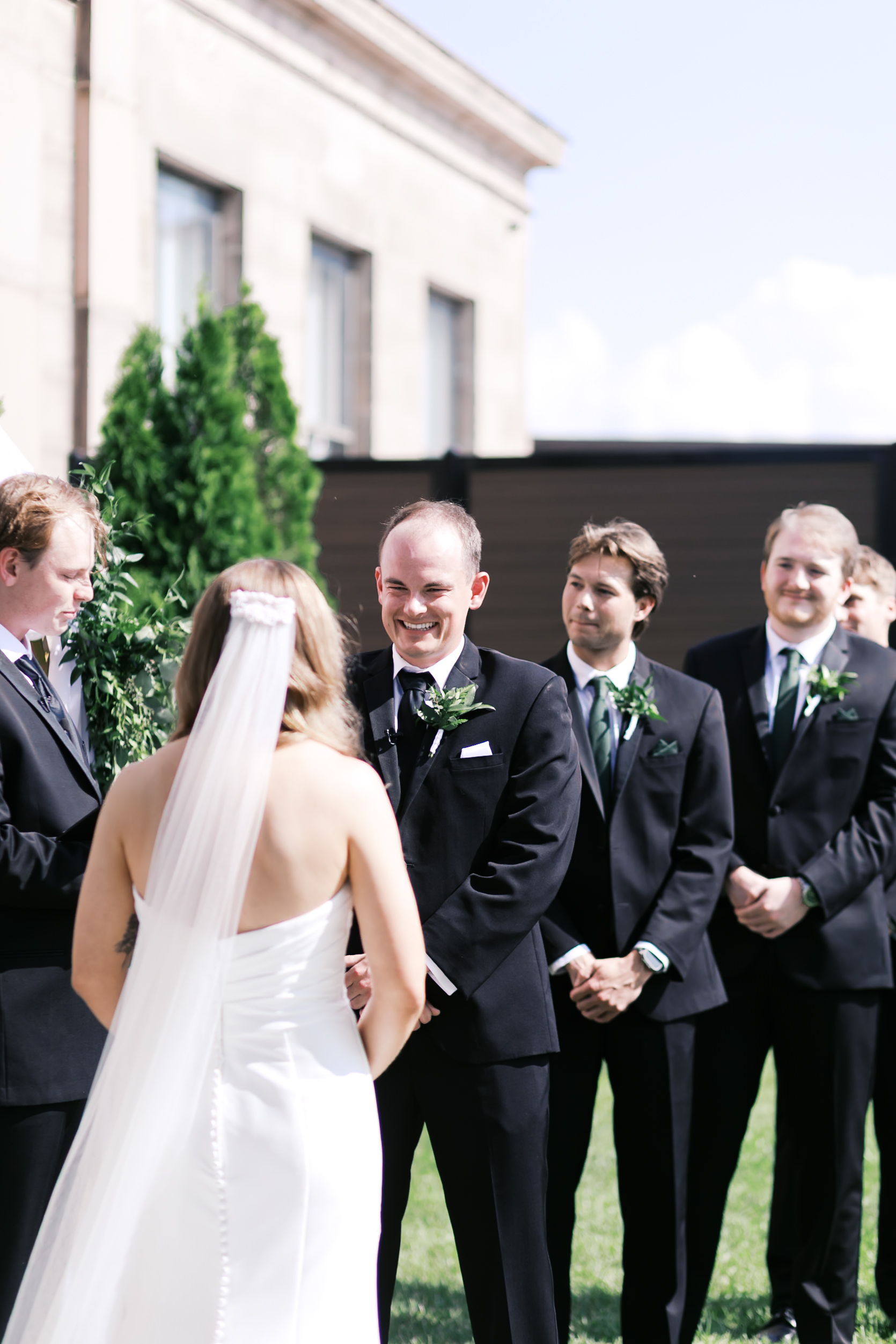 groom smiling at bride during the wedding ceremony
