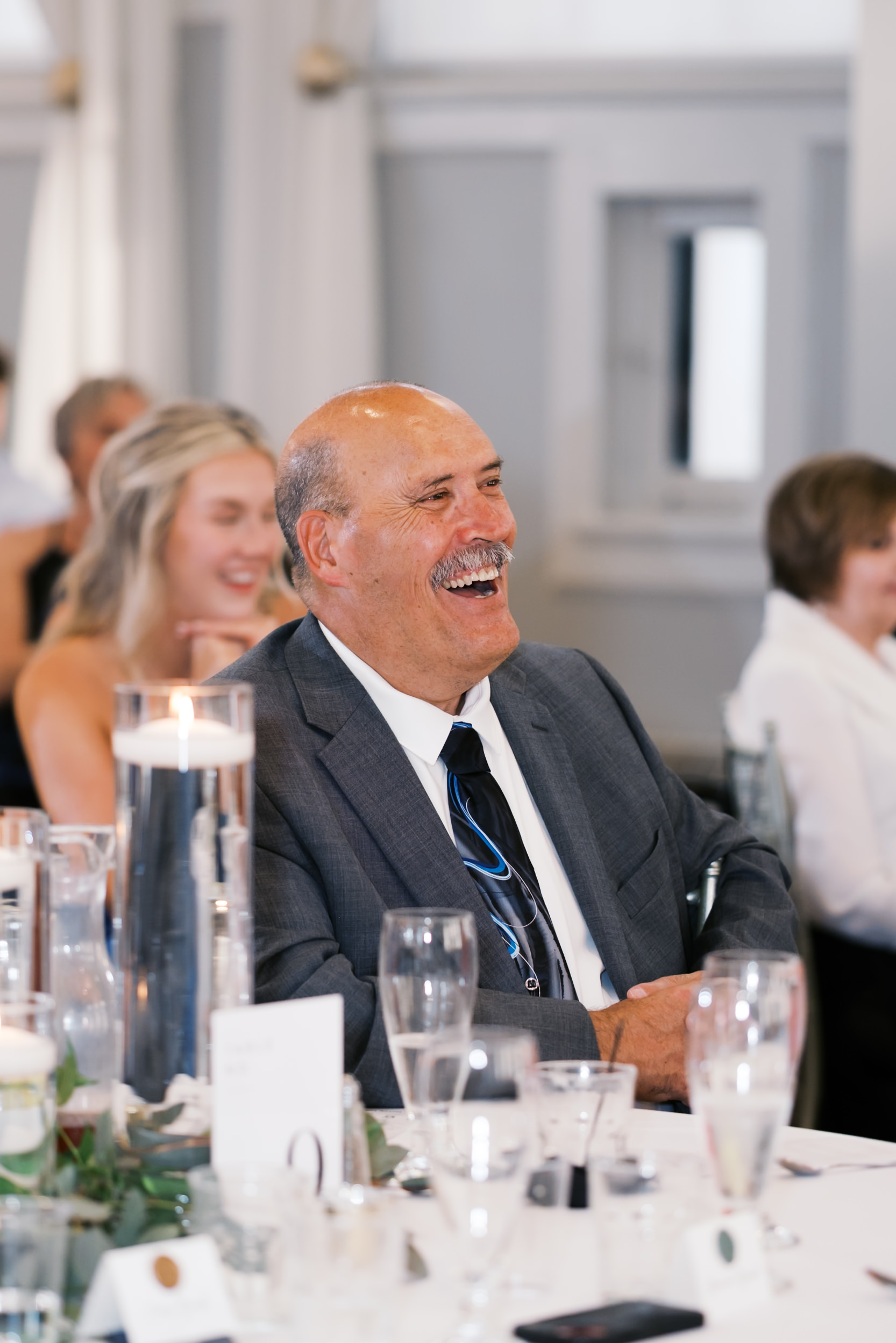 Man with mustache laughing