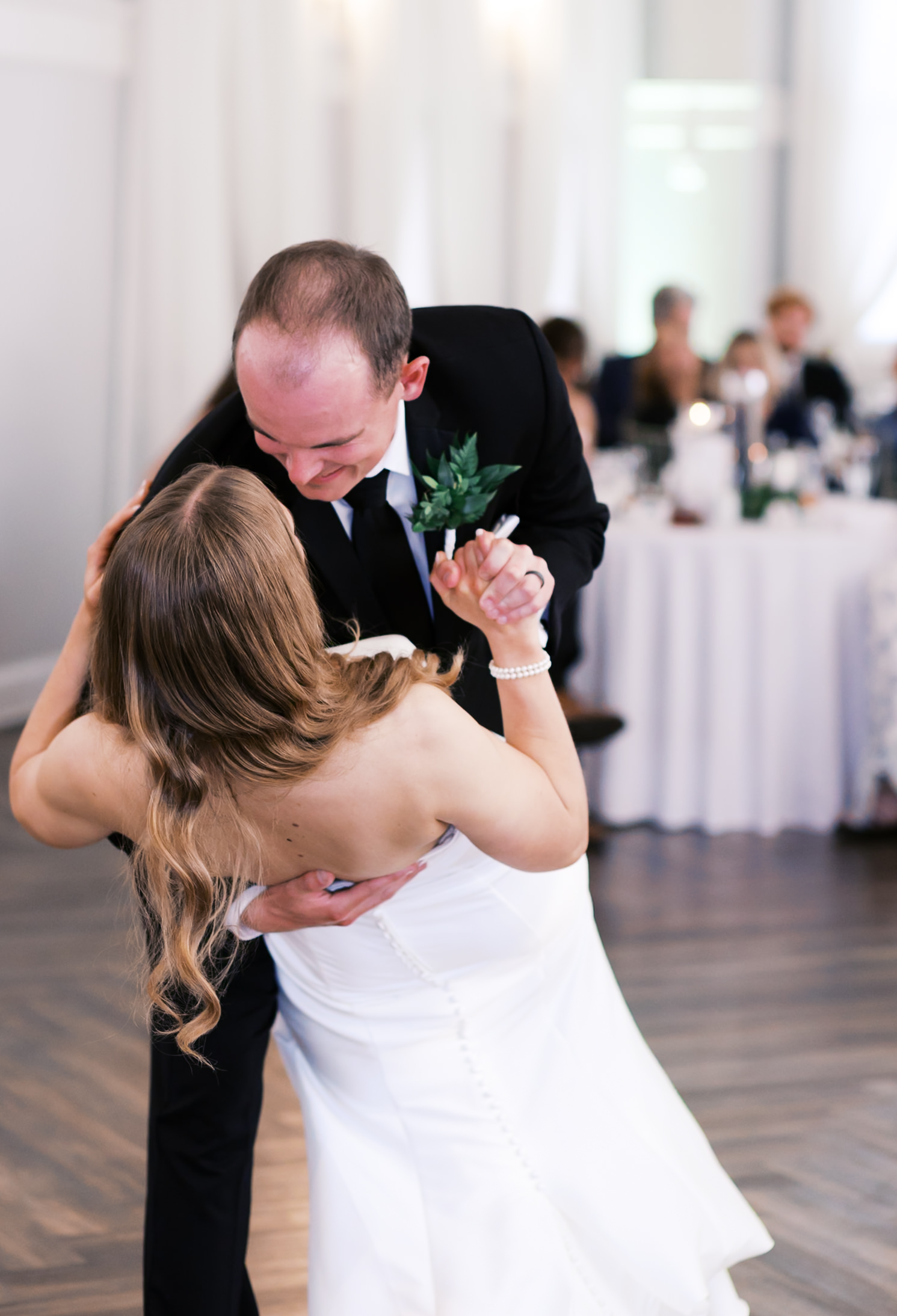 Groom dipping bride on the dance floor