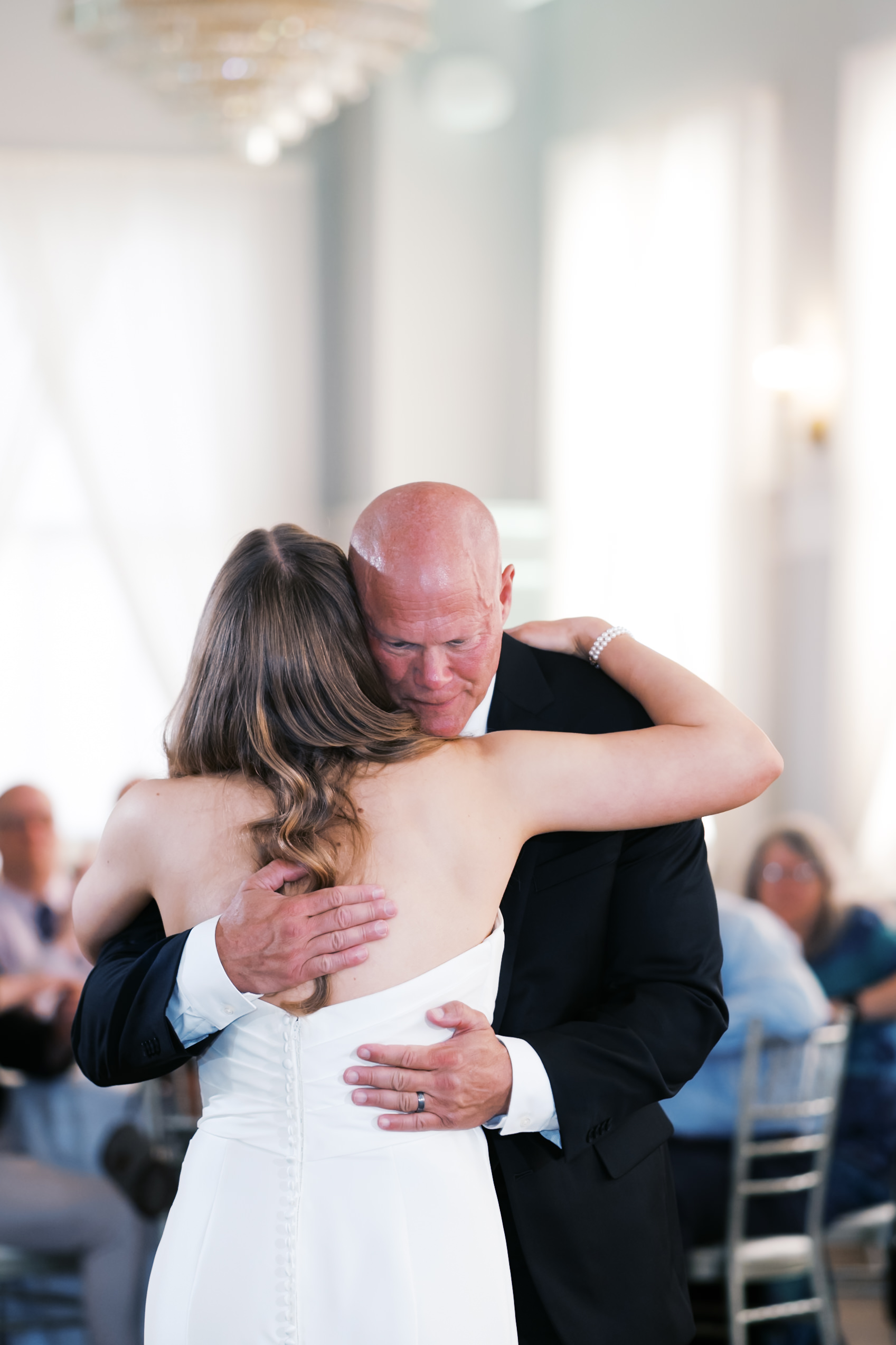 Father hugging bride