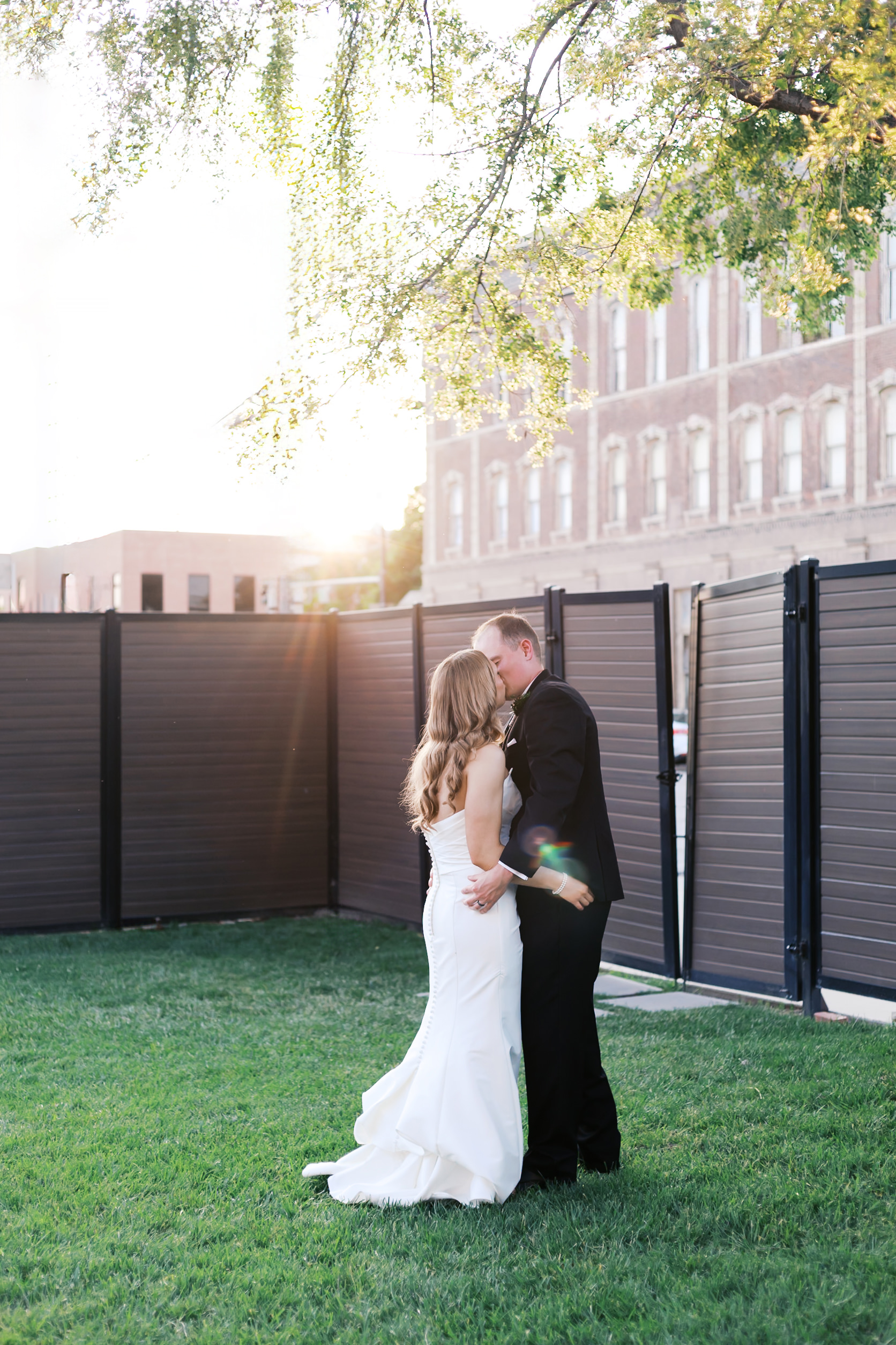 bride and groom kissing in the yard of Lincoln Event Space
