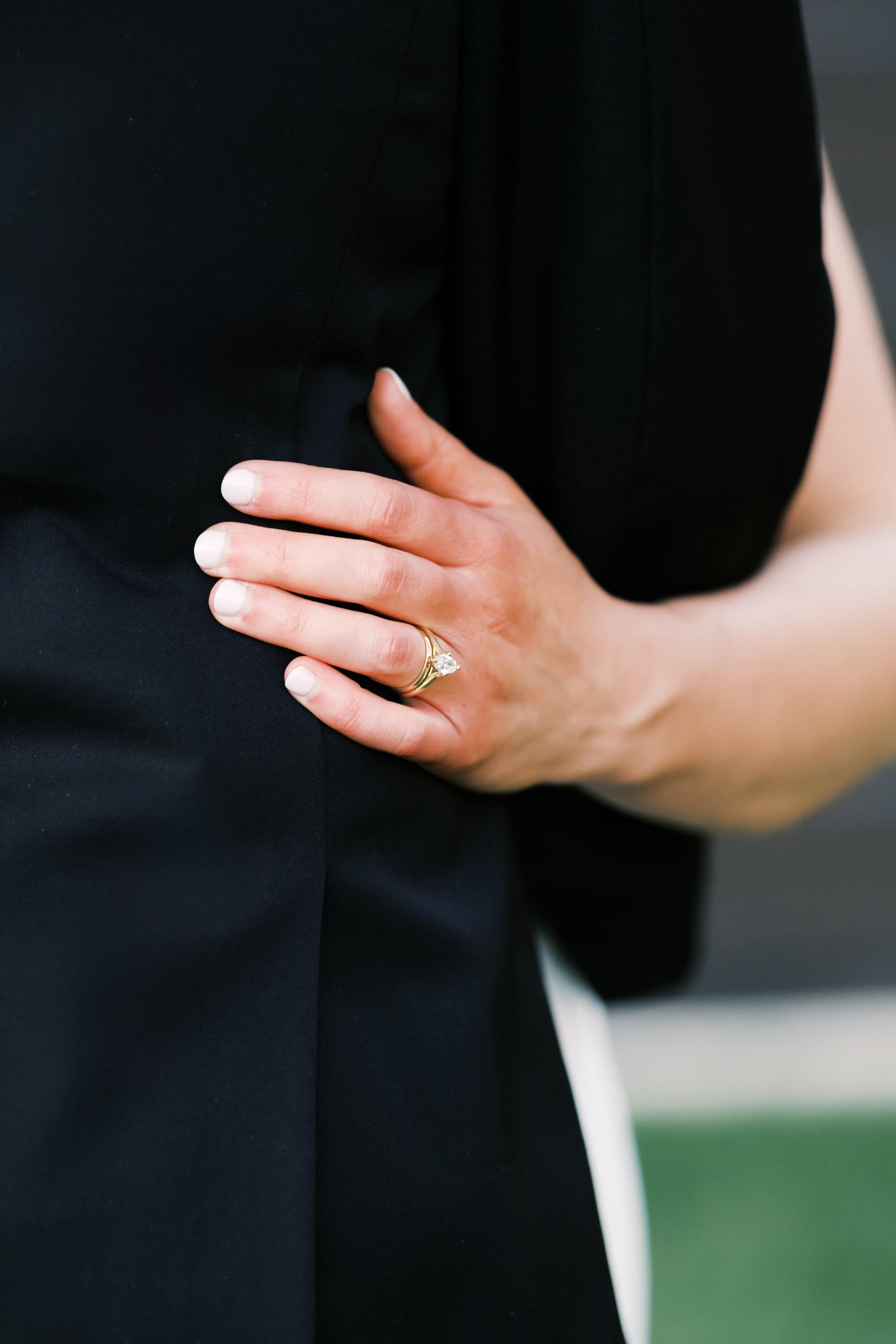 close up of bride's hand and ring on groom's back
