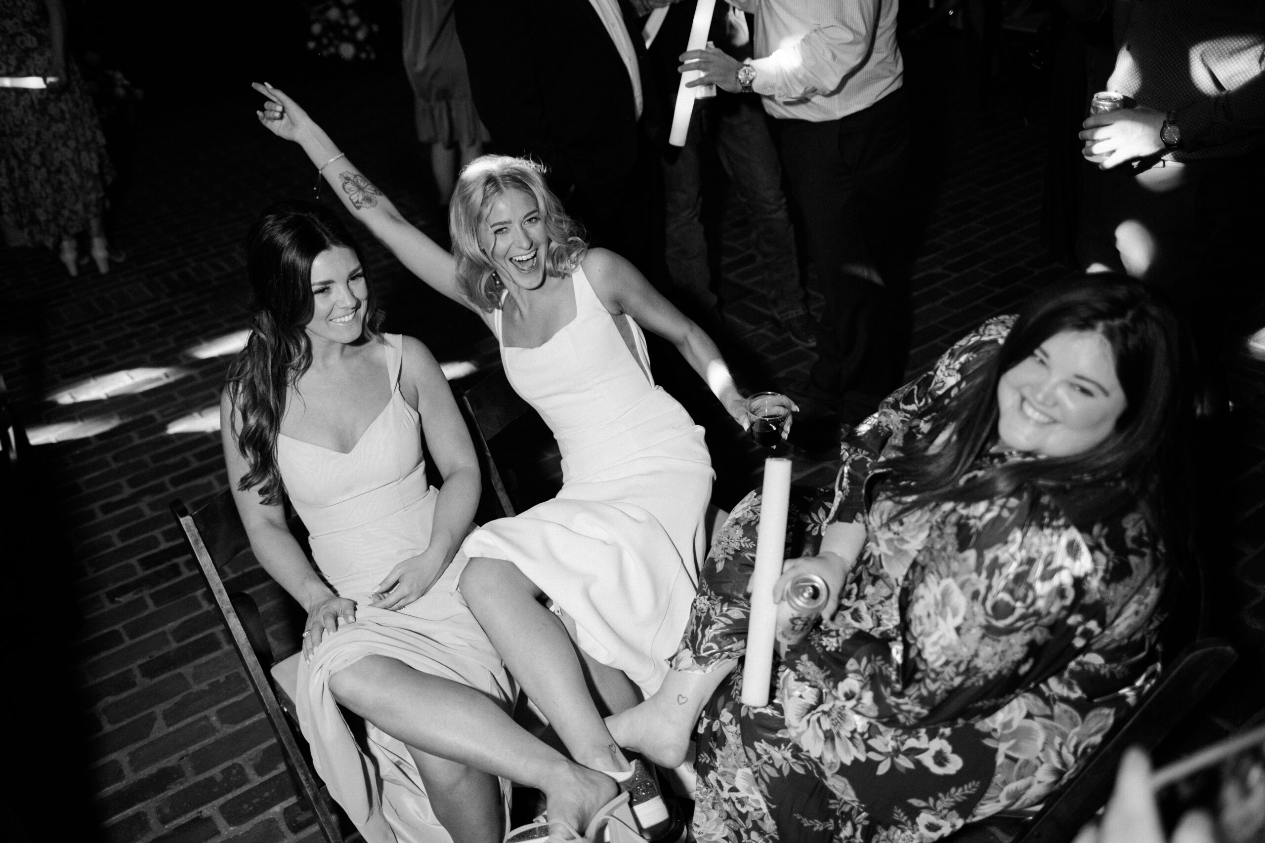 Bride posing with friends in a black and white photo