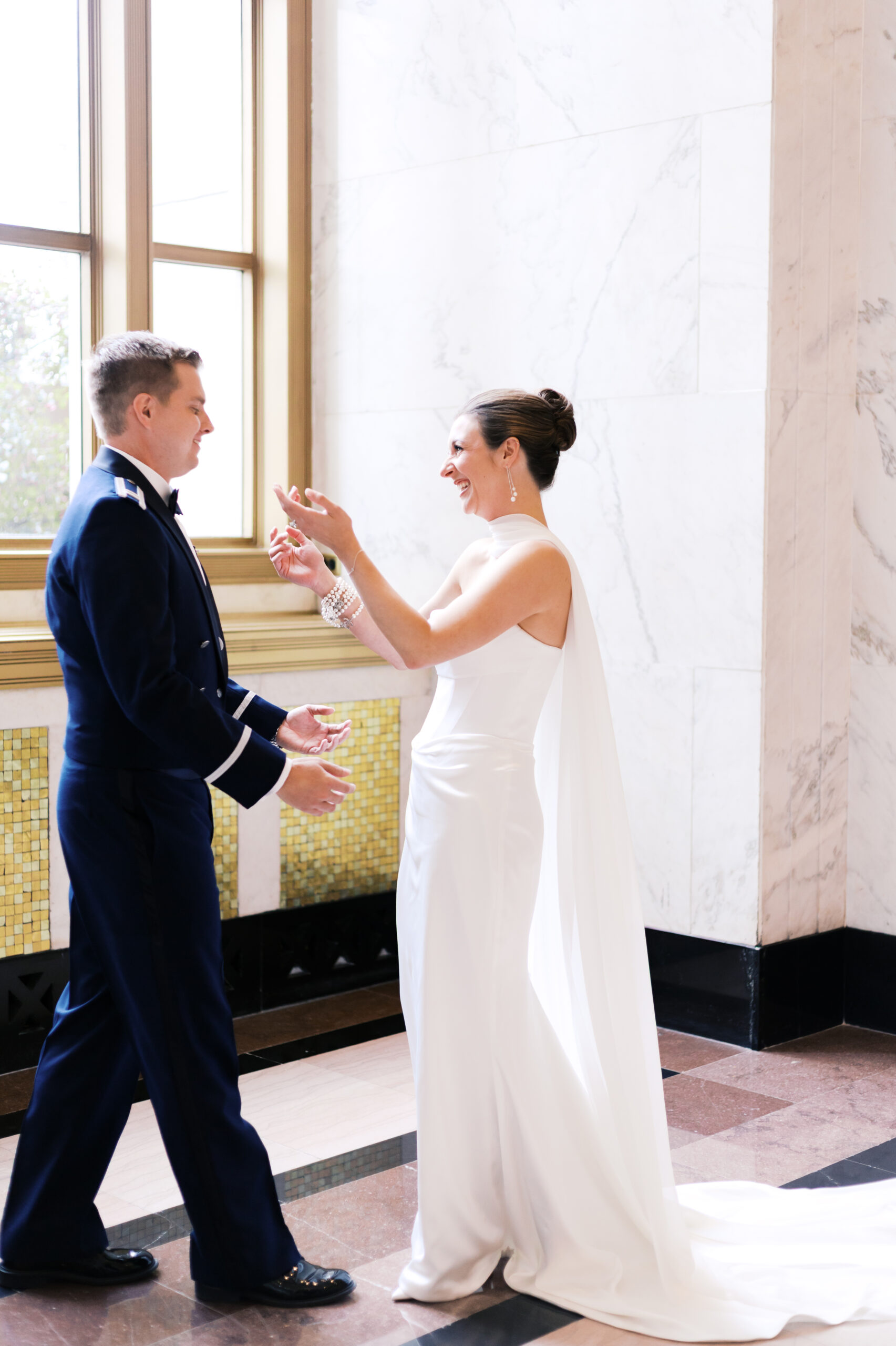 Bride and groom sharing their first look near tall windows at The Old Post Office in Chicago.
