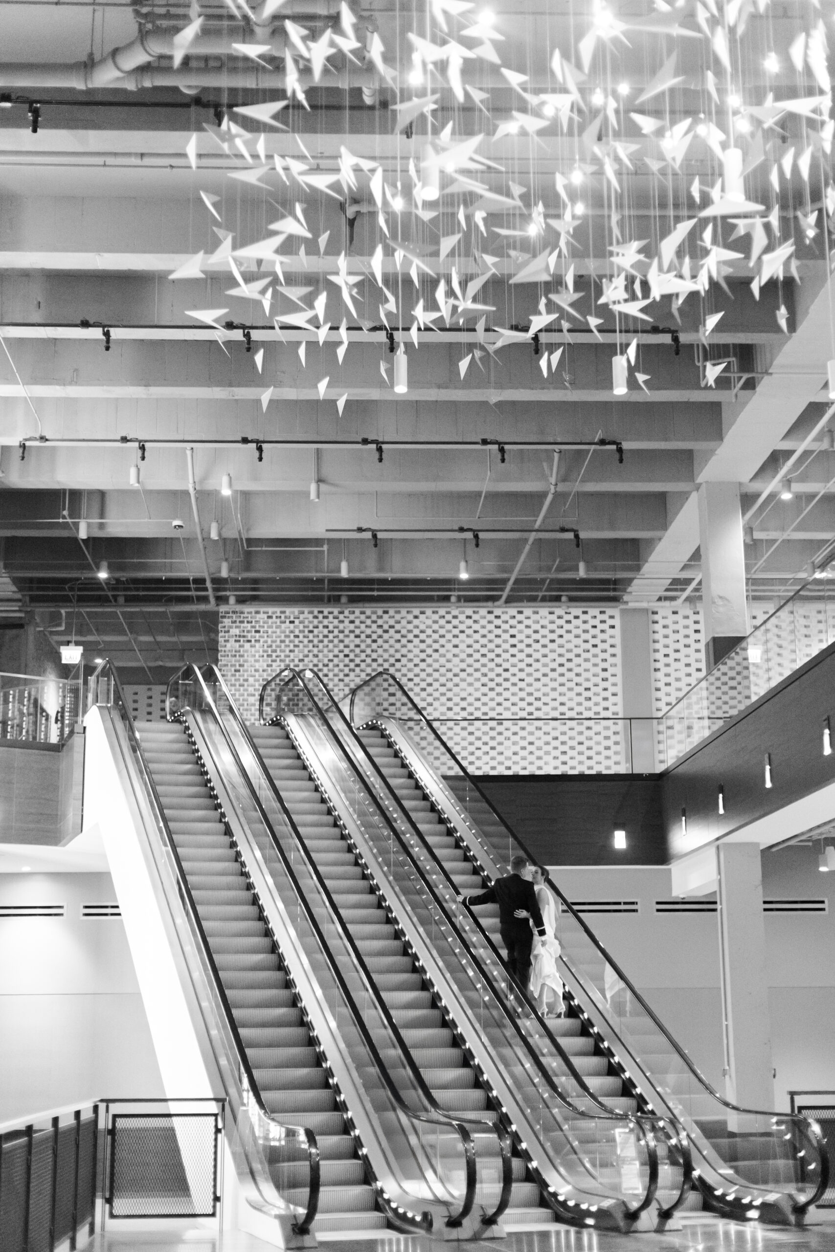 Bride and groom going up the escalator in the Old Post Office Chicago