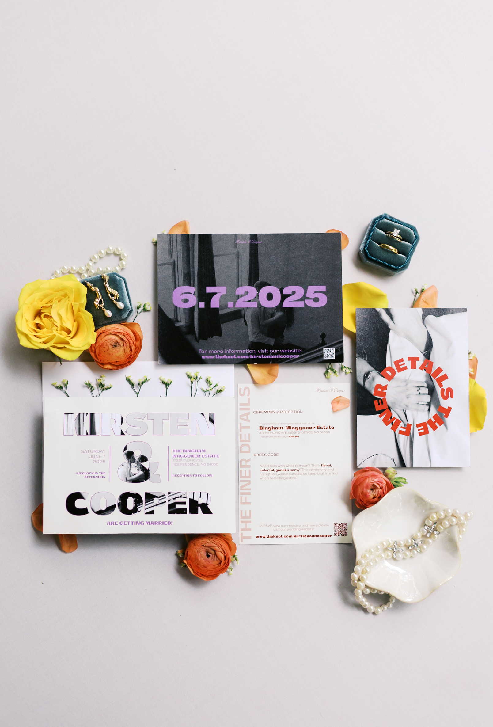 Wedding invitation suite styled with bold typography, surrounded by yellow and orange florals, pearl accessories, and velvet ring boxes.