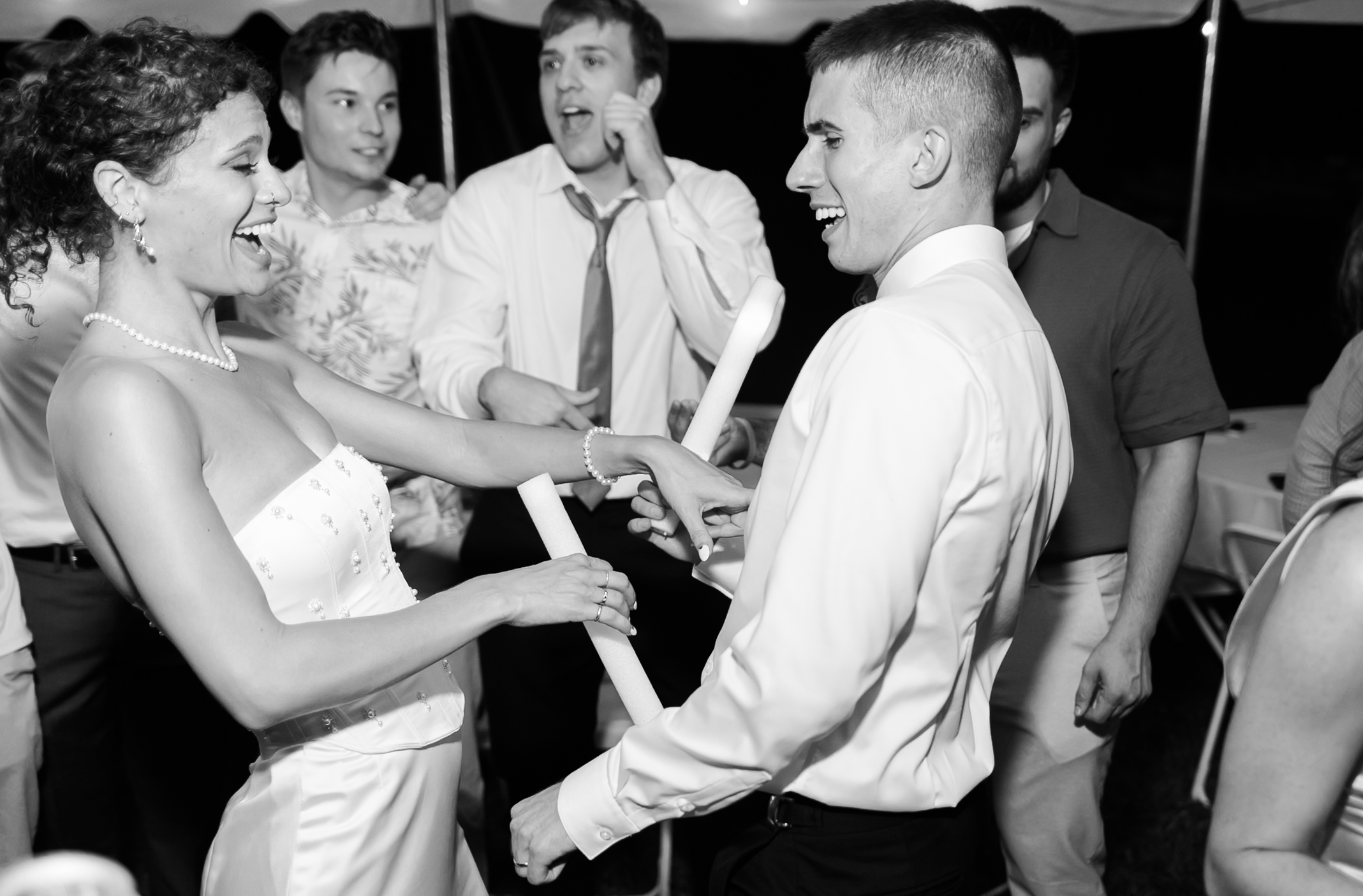 Bride and groom dancing in a black and white image.