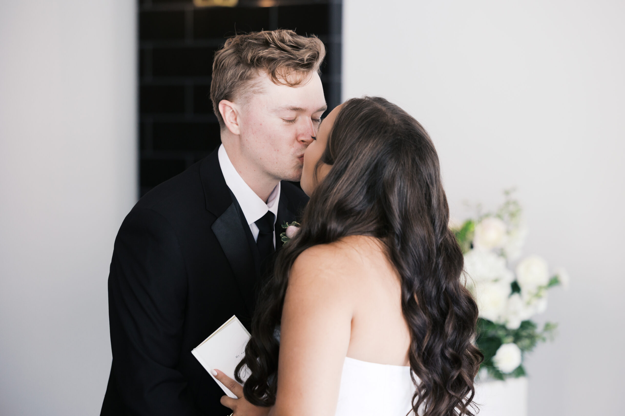 Bride and groom sharing a kiss.