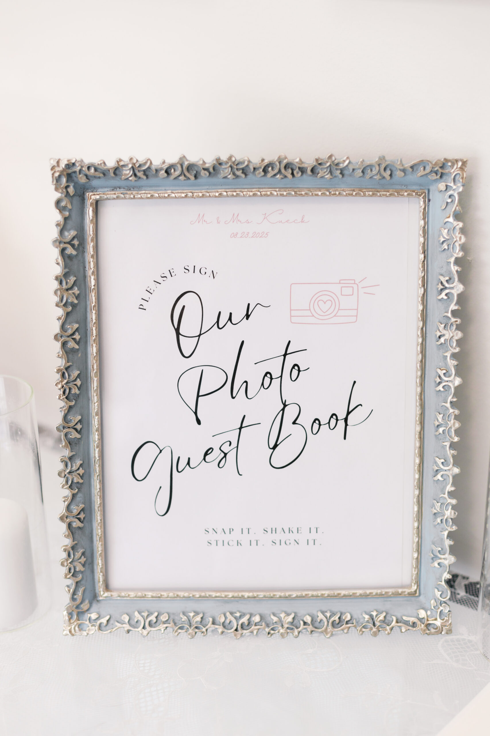 Framed sign reading "Our Photo Guest Book" with instructions for guests.