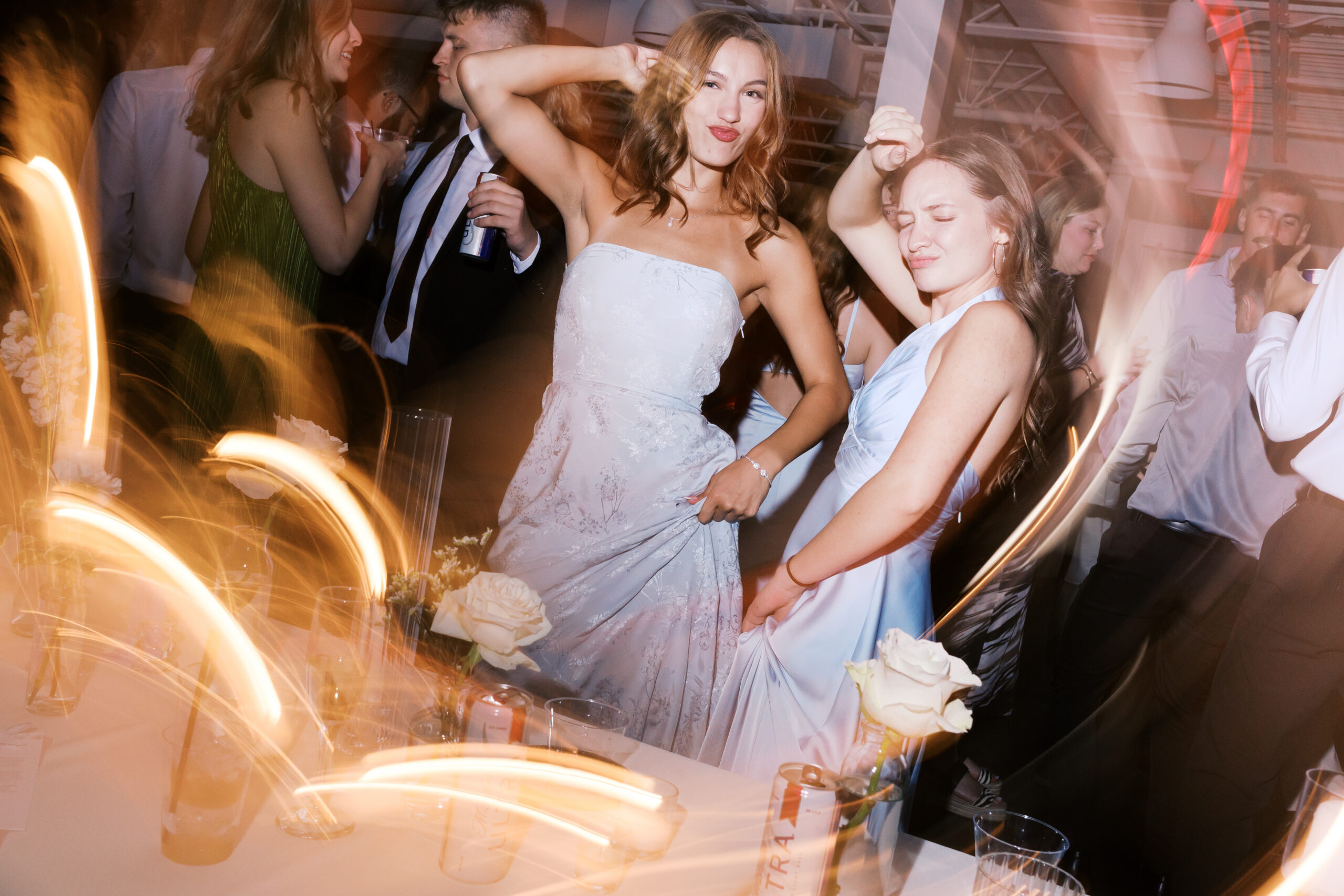Photo of two bridemaids dancing at the reception.
