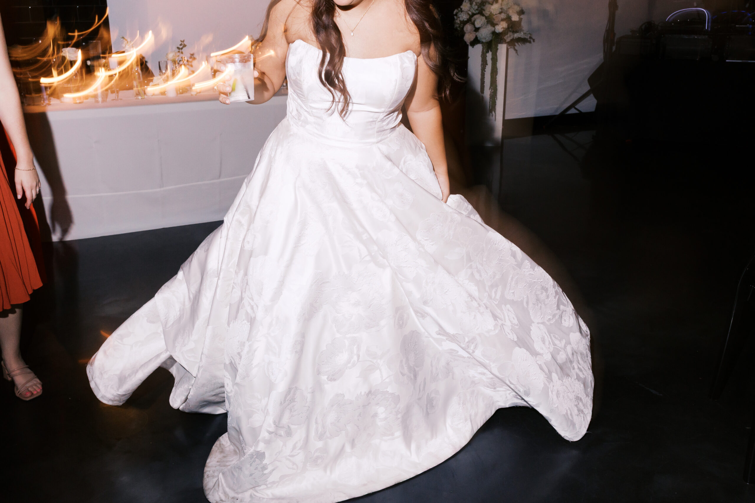 Close up of the bottom of the bride's dress as she twirls.