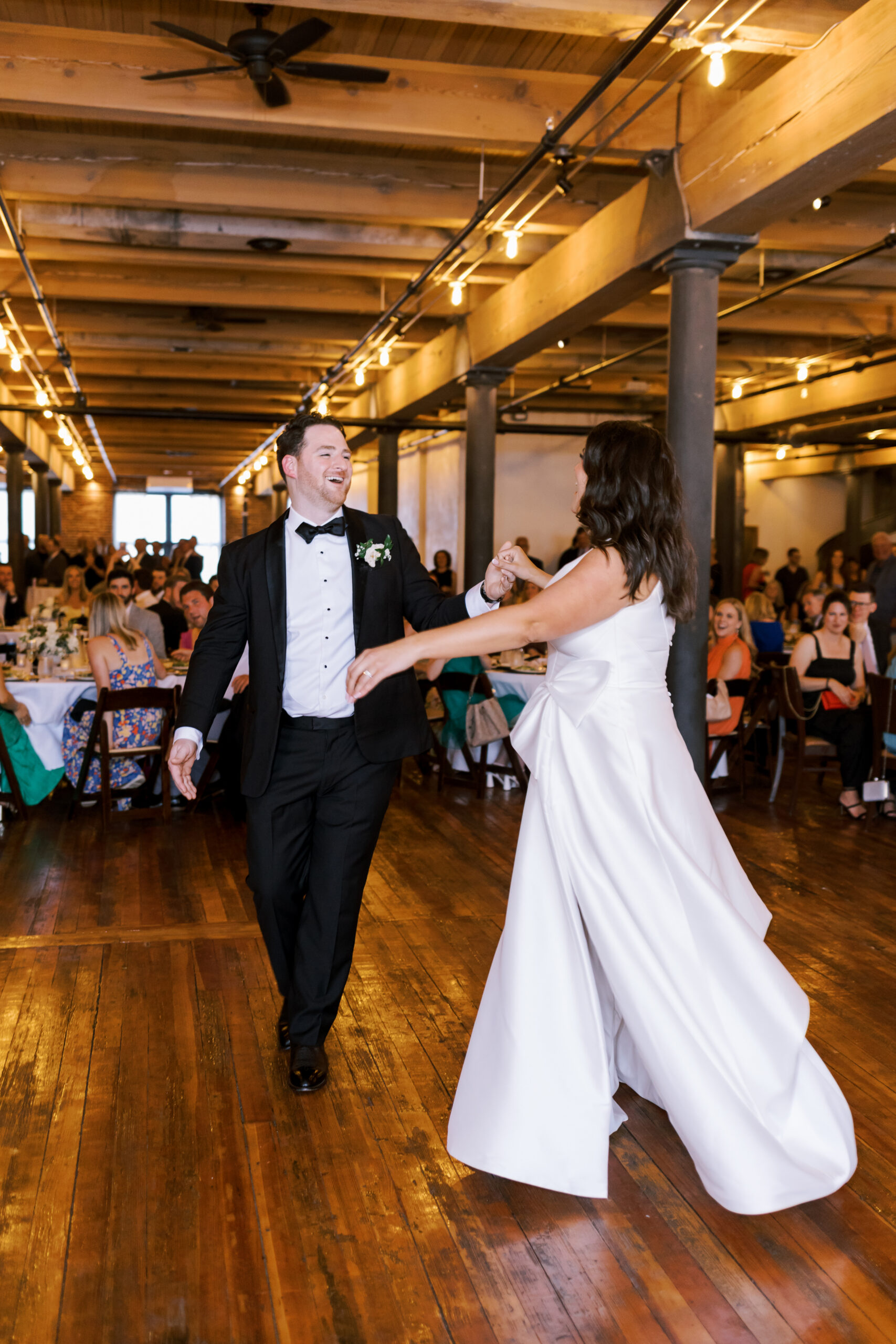 Bride and groom spinning together during their grand entrance into the reception.