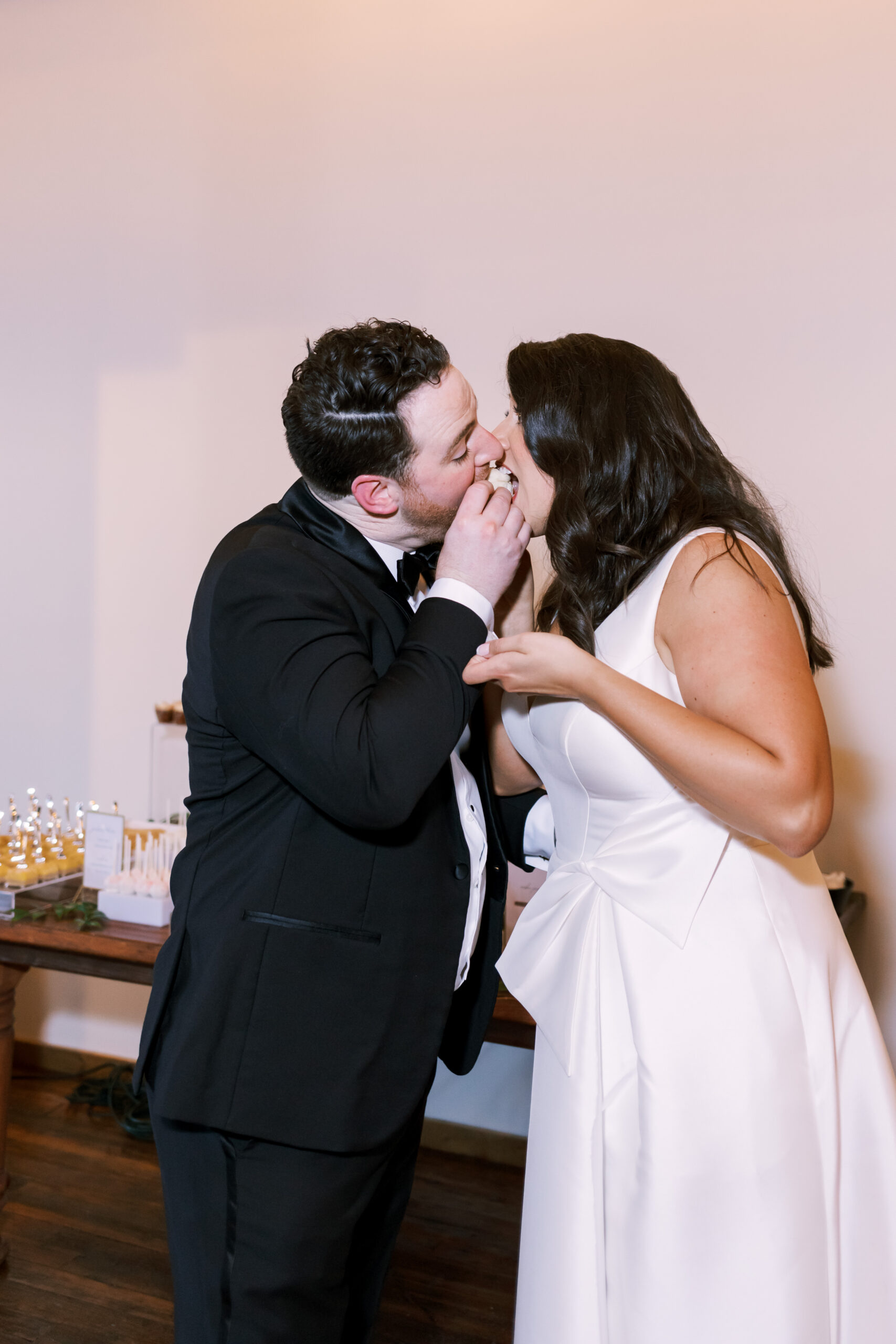 Bridesmaid reading a speech while holding a microphone in front of a brick wall stage.
