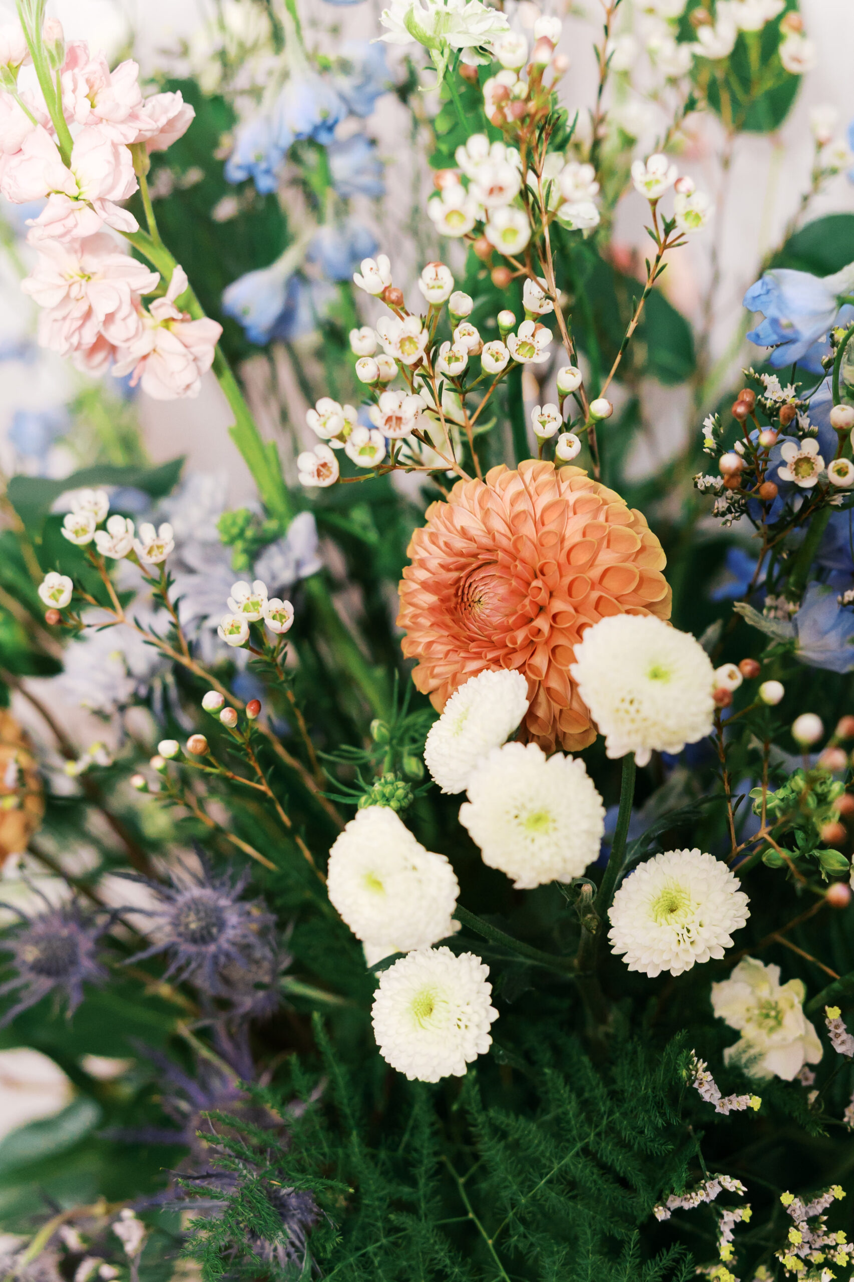 Colorful floral arrangement with mixed blooms and greenery centerpiece