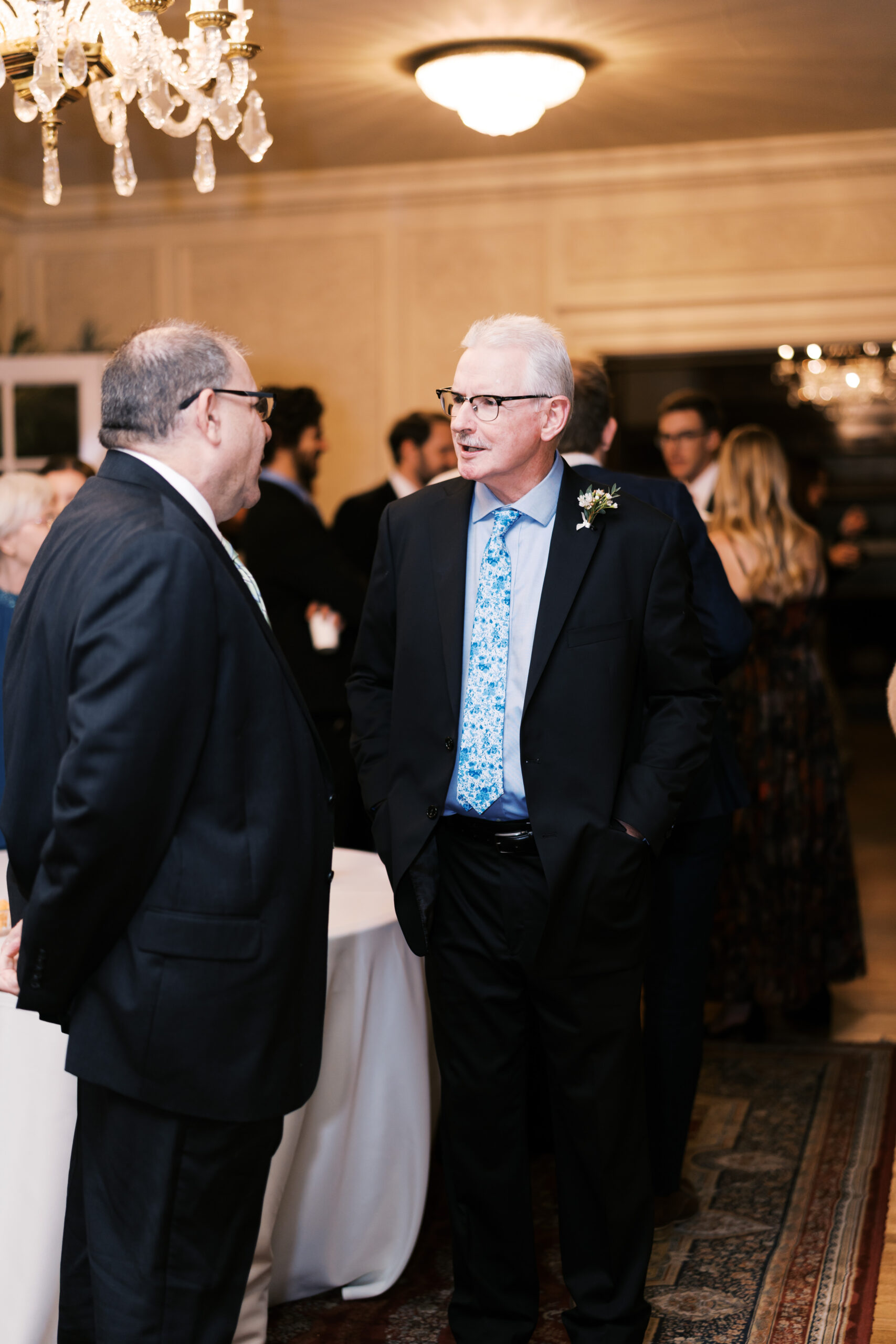 Two male guests share a conversation during cocktail hour.