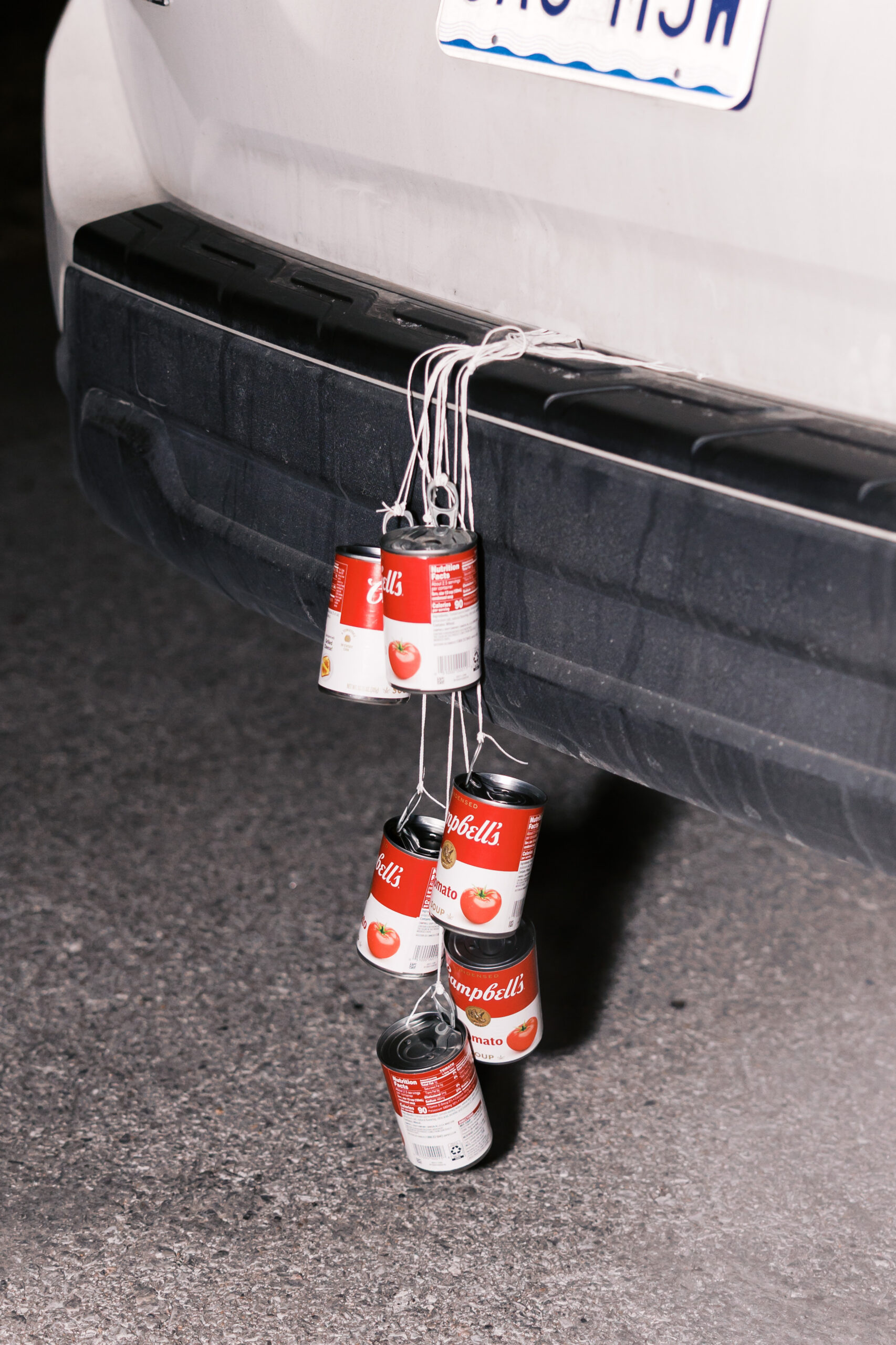 Cans tied to back of getaway car with string for wedding send-off tradition
