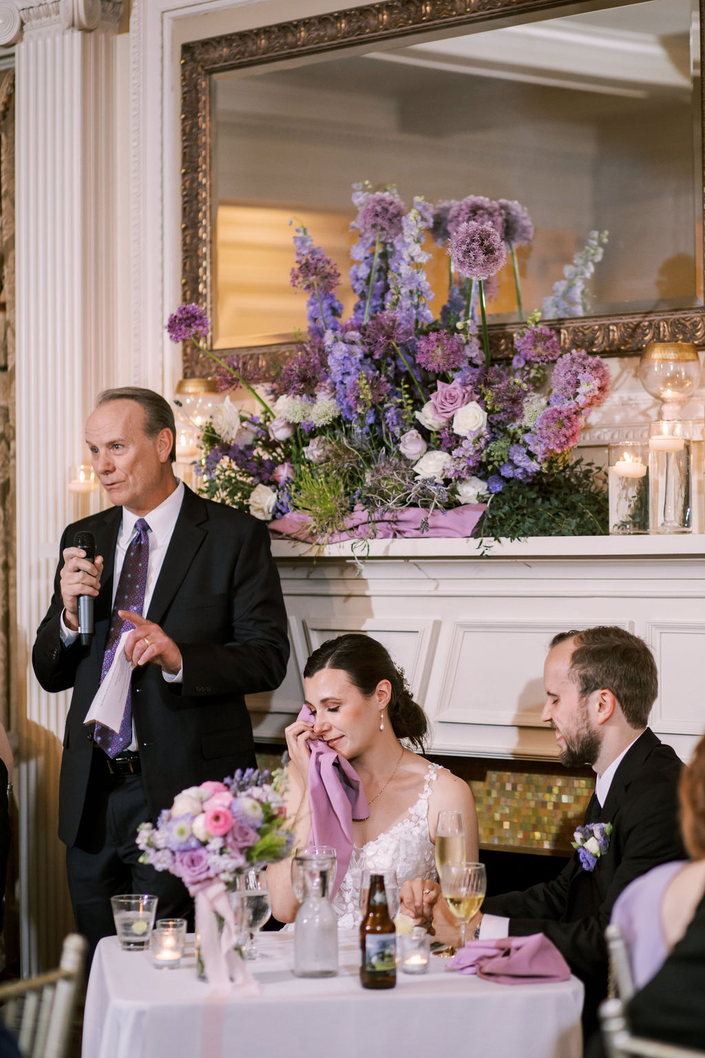 Father giving an emotional wedding toast while the bride wipes away tears during the reception at Loose Mansion