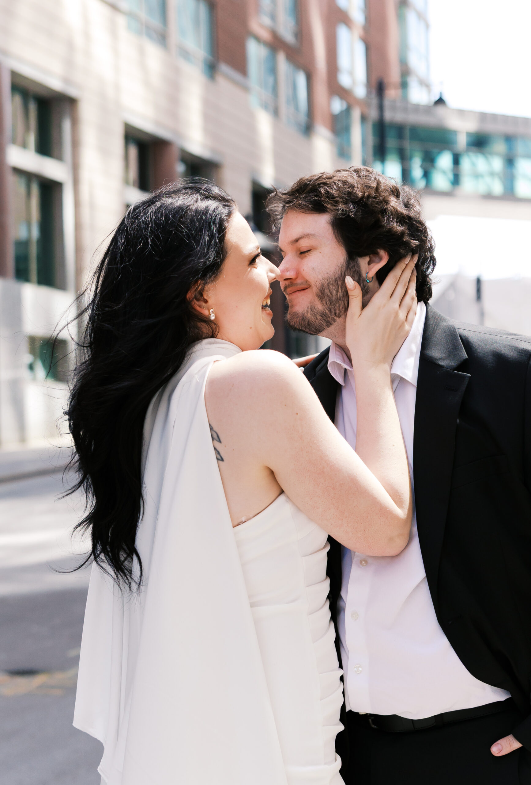 Close-up of the couple smiling together during their downtown Kansas City engagement session.