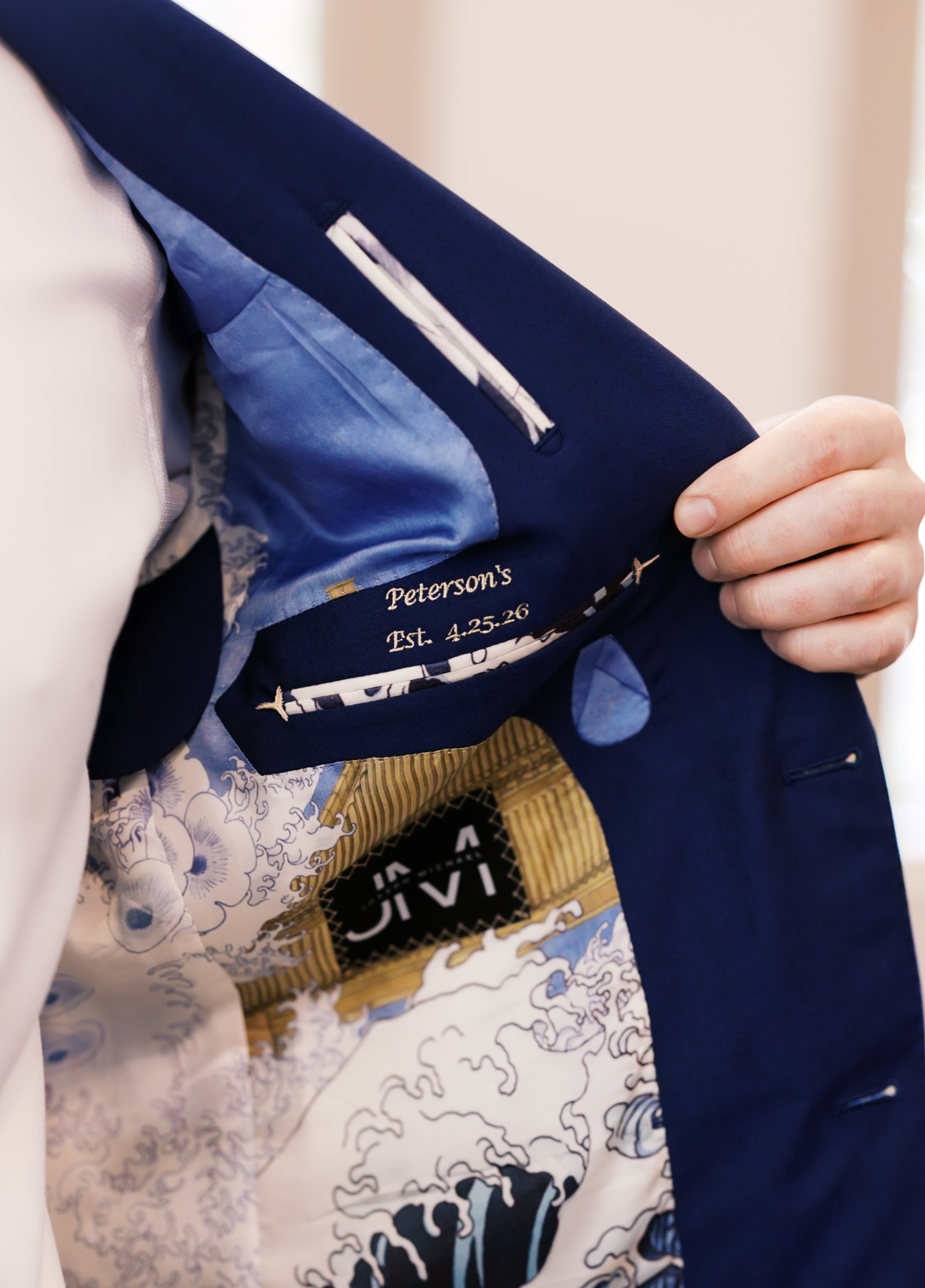 Custom embroidered wedding suit lining with the couple's name and wedding date inside the groom's jacket.