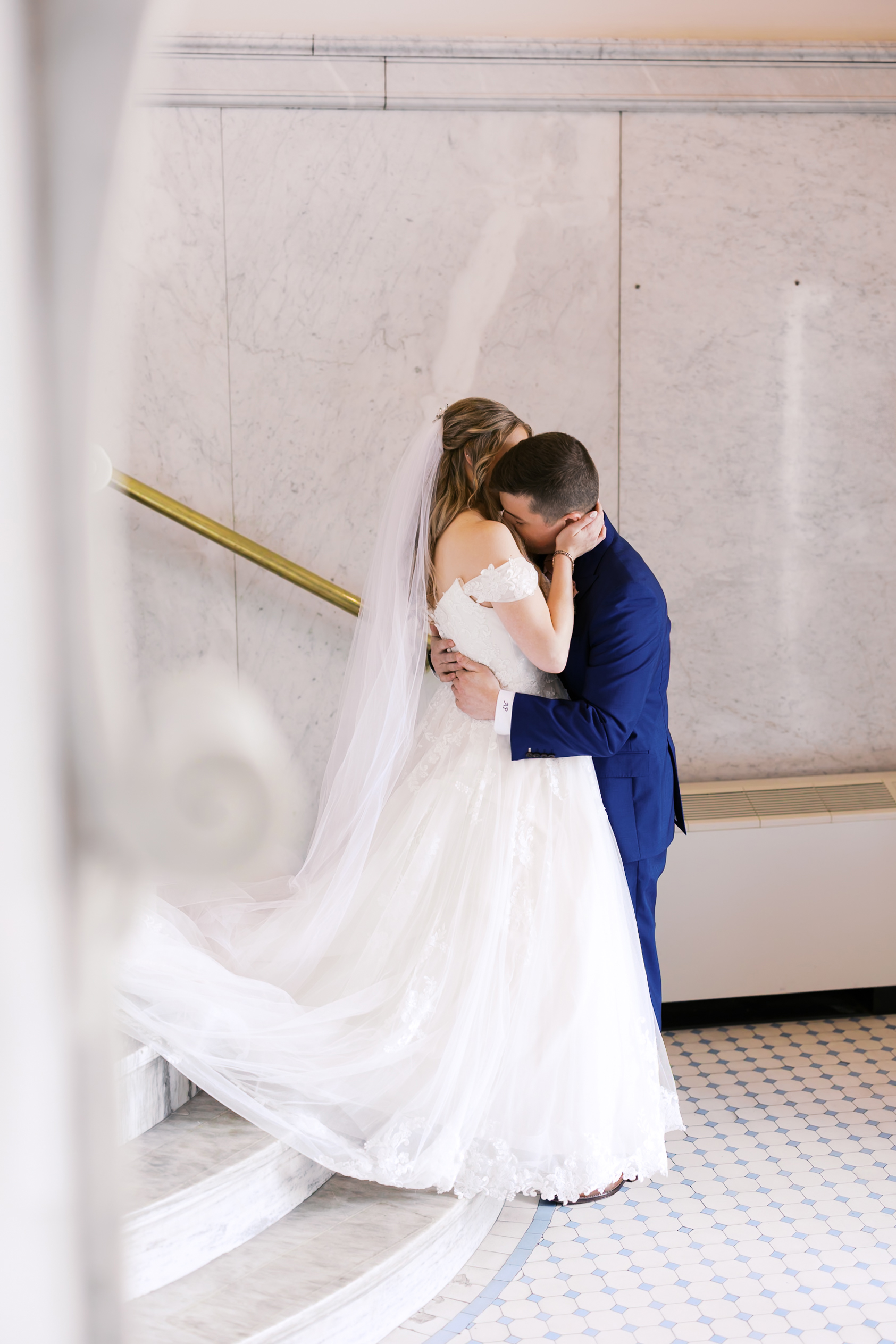 Bride and groom sharing a quiet embrace during their first look.