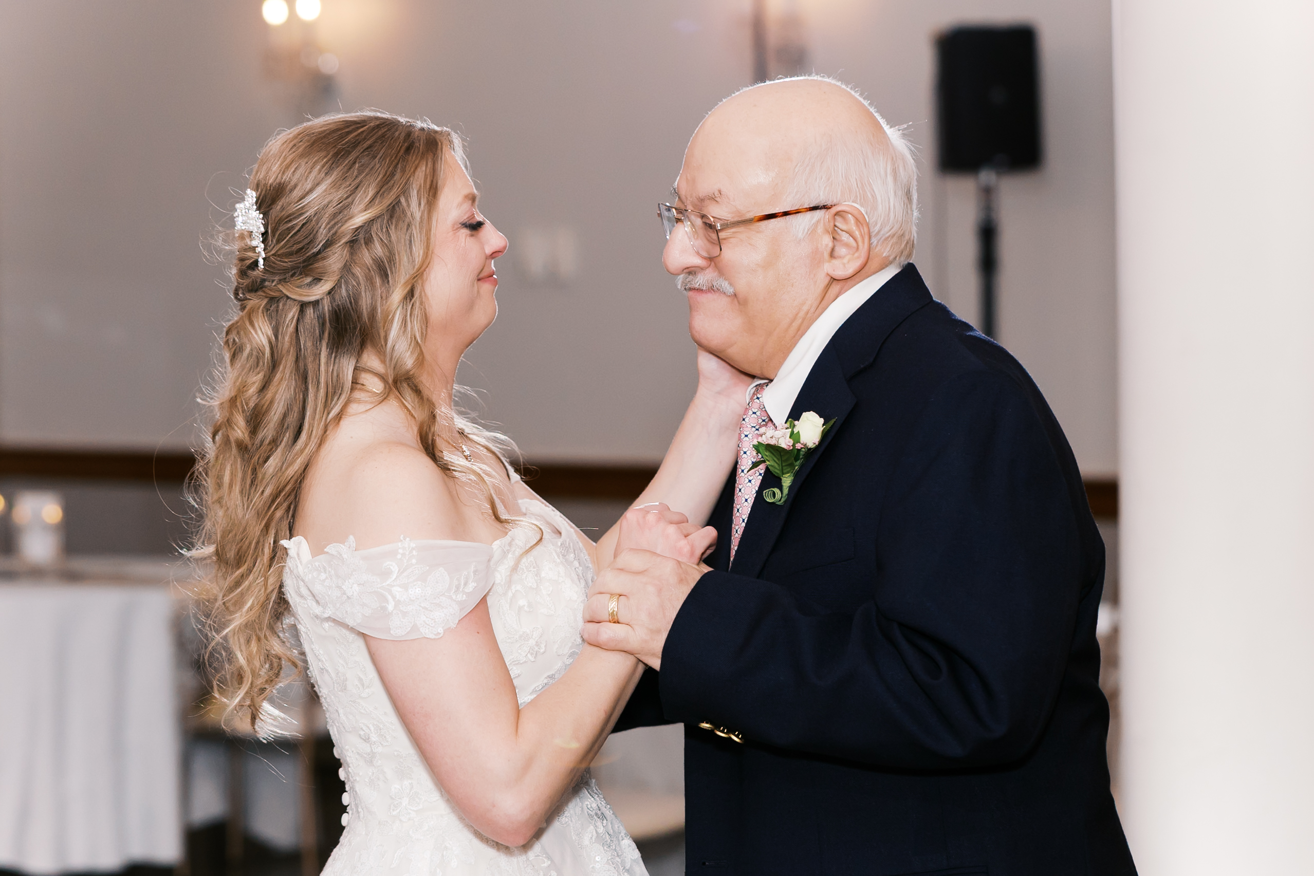 Bride shares an emotional dance with an older family member during the wedding reception.