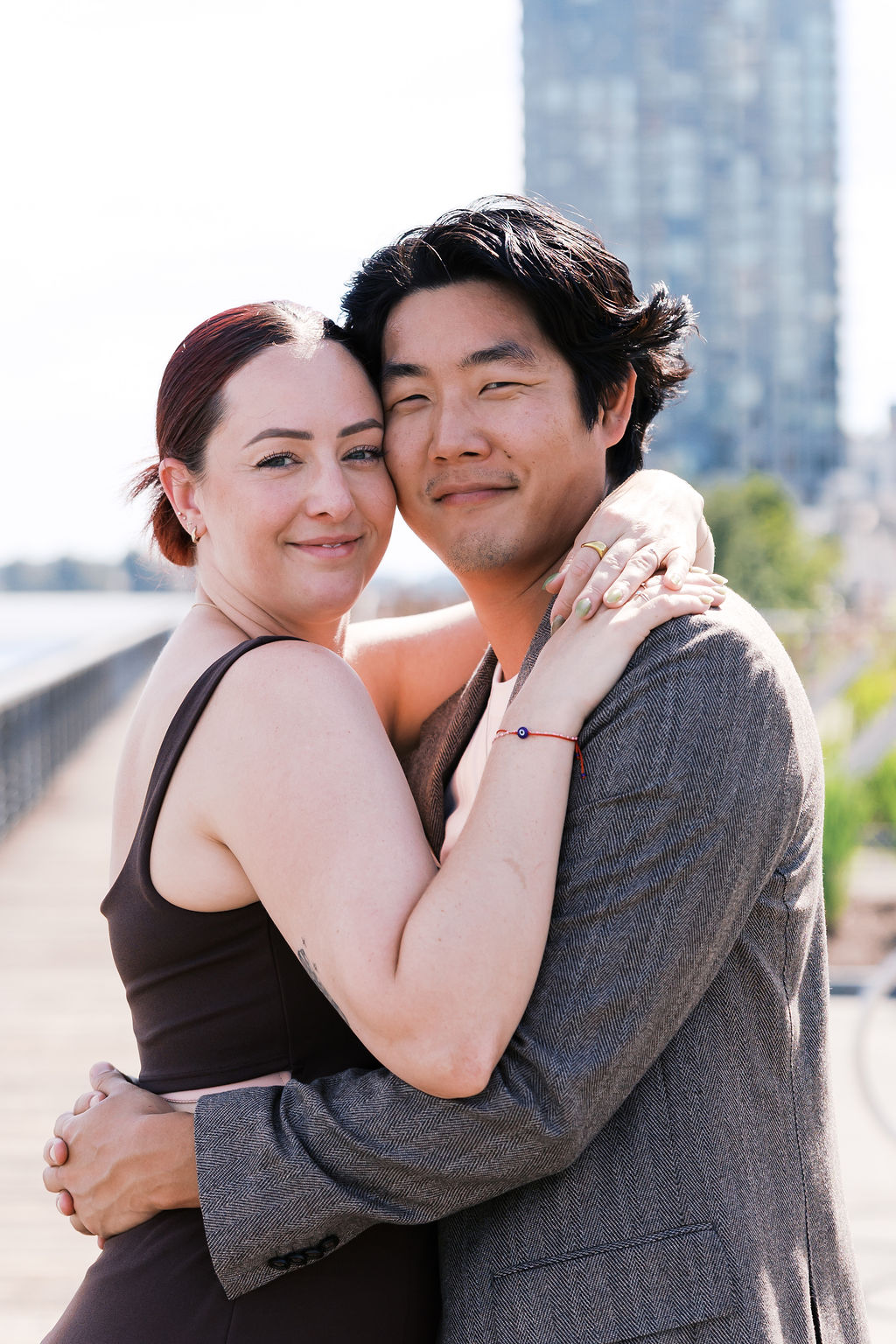 Close portrait of the engaged couple embracing and smiling at the camera.