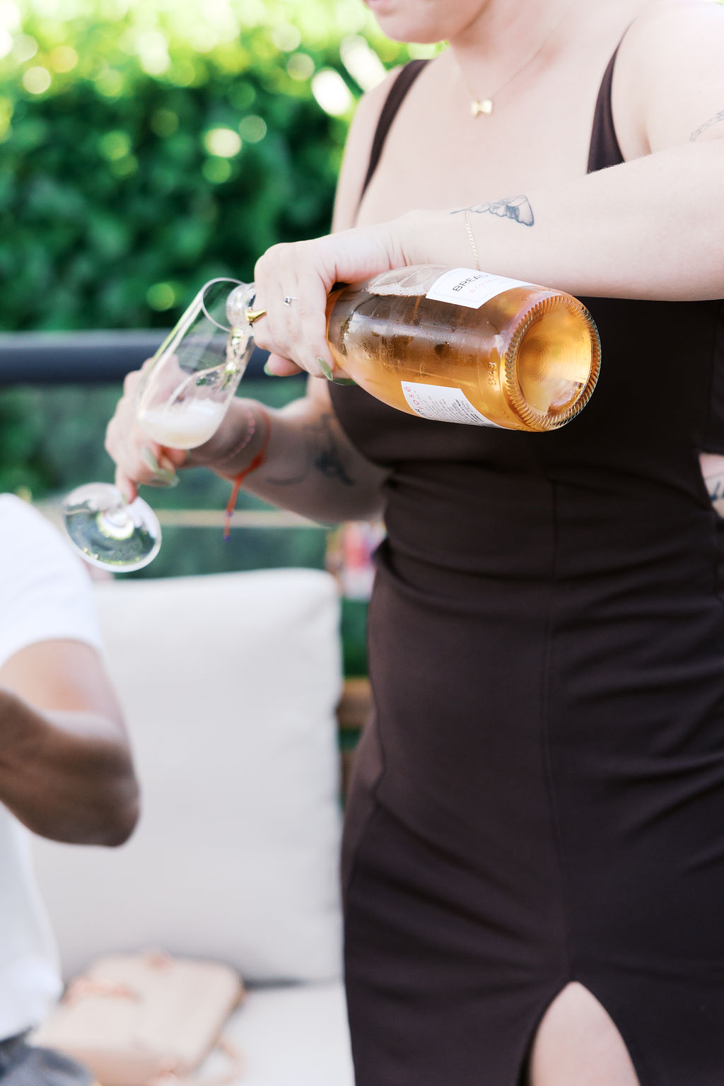 Close-up of sparkling wine being poured into a champagne glass during the engagement celebration.