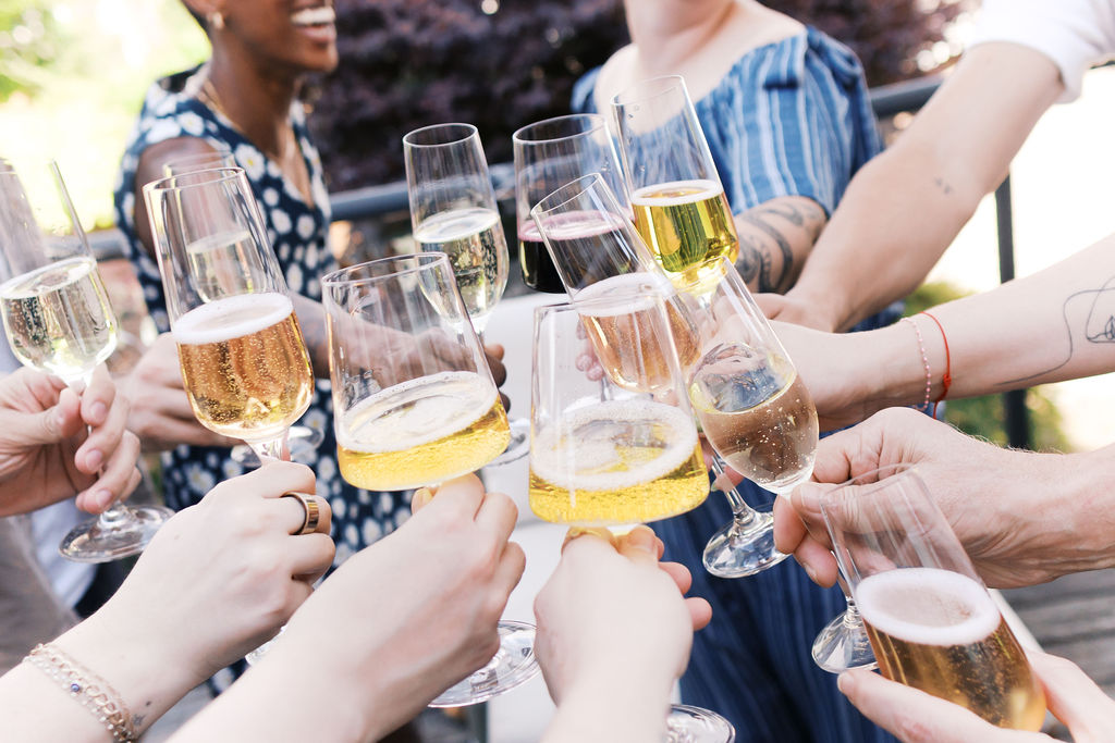 Family and friends raise glasses for a celebratory toast after the engagement.